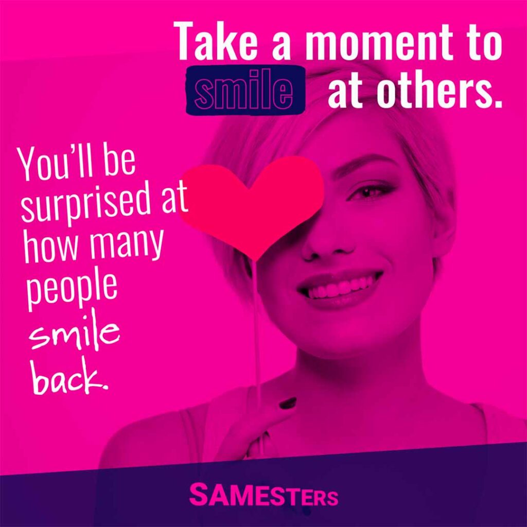 Image of a woman holding a heart on a stick with text overlayed saying: "Take a moment to smile at others. You’ll be surprised at how many people smile back."